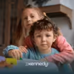 Two siblings, a girl and a boy, hugging together