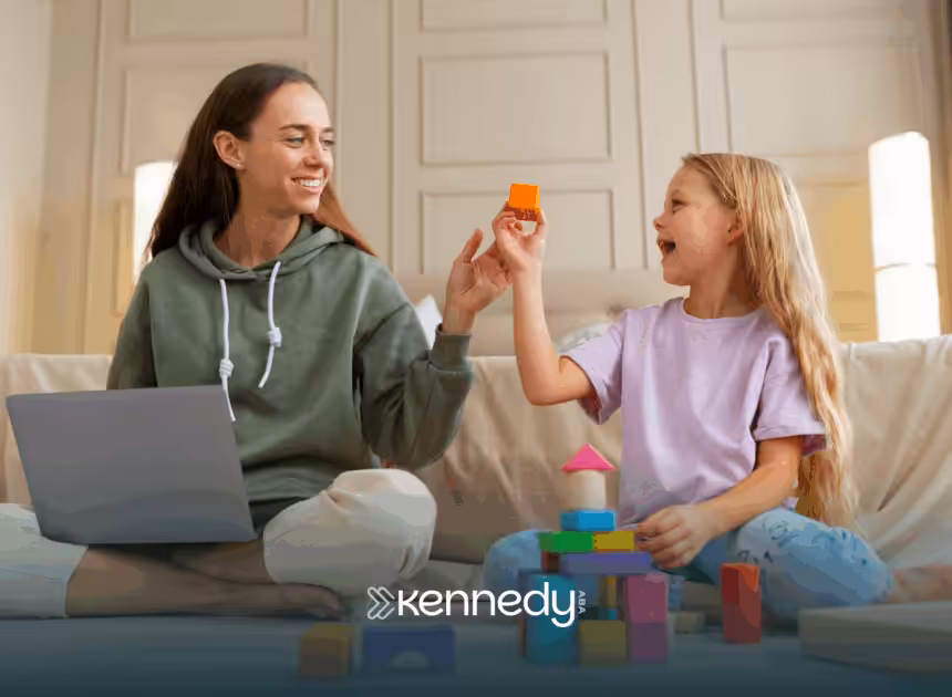 A 7-year-old and an RBT sitting on a couch during ABA therapy
