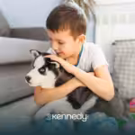 A kid with autism is holding his pet dog