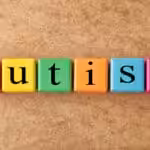 Colorful cubes that spell the word "autism"