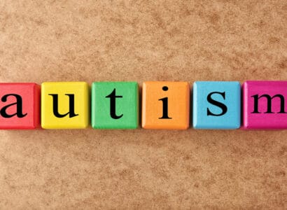 Colorful cubes that spell the word "autism"