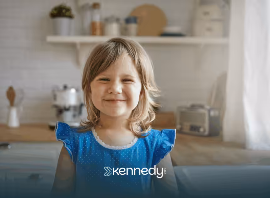 A girl sitting in a kitchen, smiling