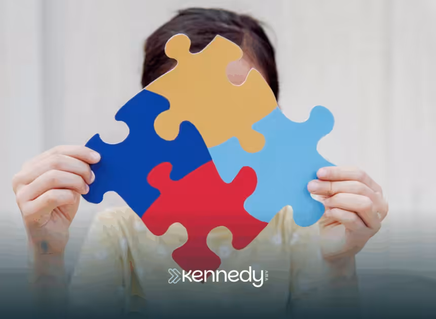 A kid is holding four puzzle pieces