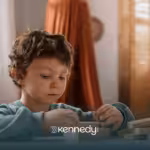 A kid with autism playing on a table