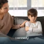 An RBT comforting a kid with autism looking upset during ABA therapy