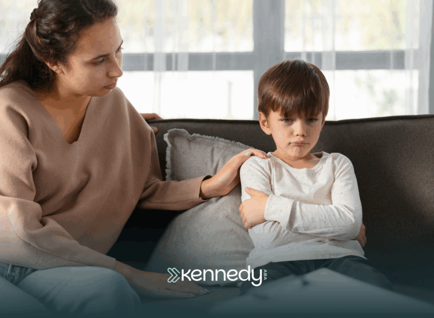 An RBT comforting a kid with autism looking upset during ABA therapy