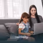 A kid with autism and his mom sitting on a couch, answering an online autism test