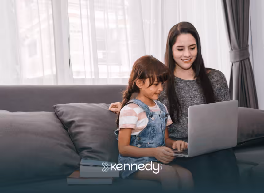 A kid with autism and his mom sitting on a couch, answering an online autism test