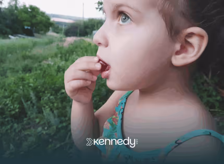 A child with autism biting on a grape