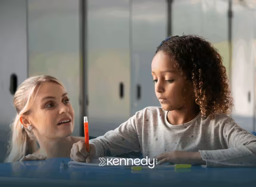 An RBT is helping a kid with autism write during ABA therapy