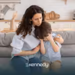 A mom is comforting her son with autism after he hurt himself