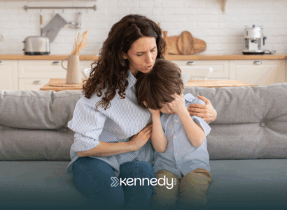 A mom is comforting her son with autism after he hurt himself