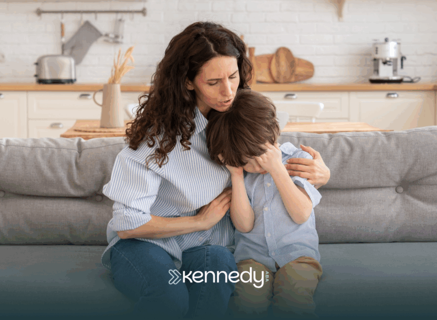 A mom is comforting her son with autism after he hurt himself