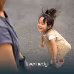 A kid with autism happily looking at her mother