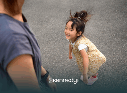 A kid with autism happily looking at her mother