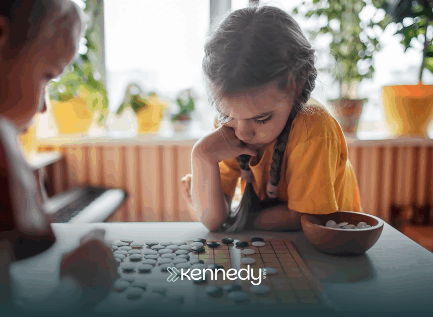 A kid is focused while playing a board game with her siblign