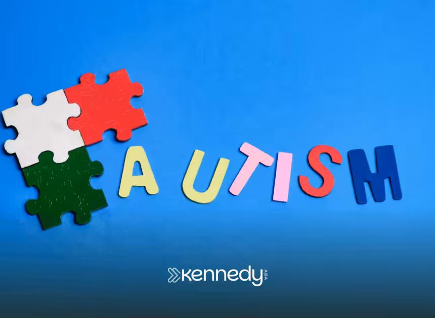 A cutout of the word "autism" and puzzle pieces on a blue background