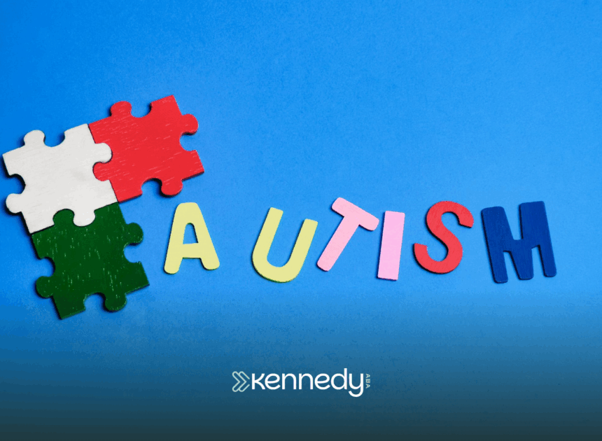 A cutout of the word "autism" and puzzle pieces on a blue background