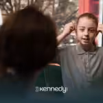 A kid explaining something to an ABA therapist