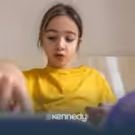 A girl with autism focused on reading a book