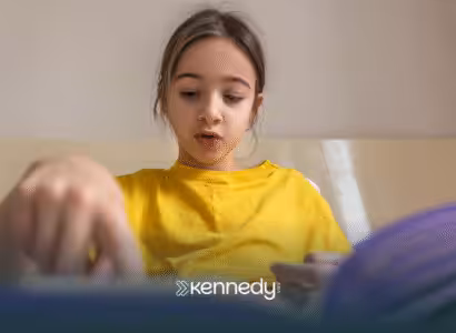A girl with autism focused on reading a book