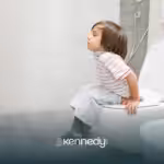 A kid with autism sitting on a toilet, potty training