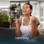 An autistic adult in the office, looking happy and fulfilled