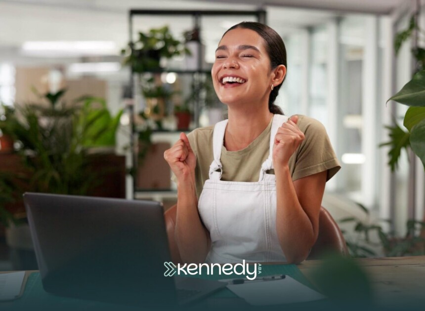 An autistic adult in the office, looking happy and fulfilled