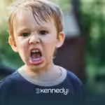 A kid with autism showing an angry face