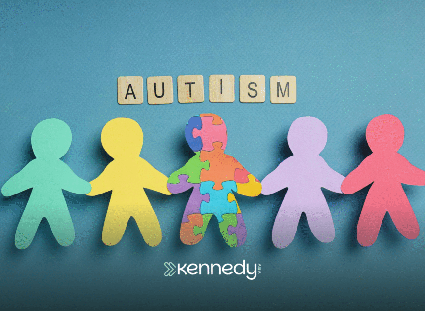 A cutout of colorful papers in human shape holding hands together with a cutout of paper squares that spells the word 'autism'