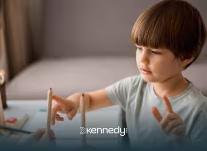 A kid with autism working on an activity during ABA therapy