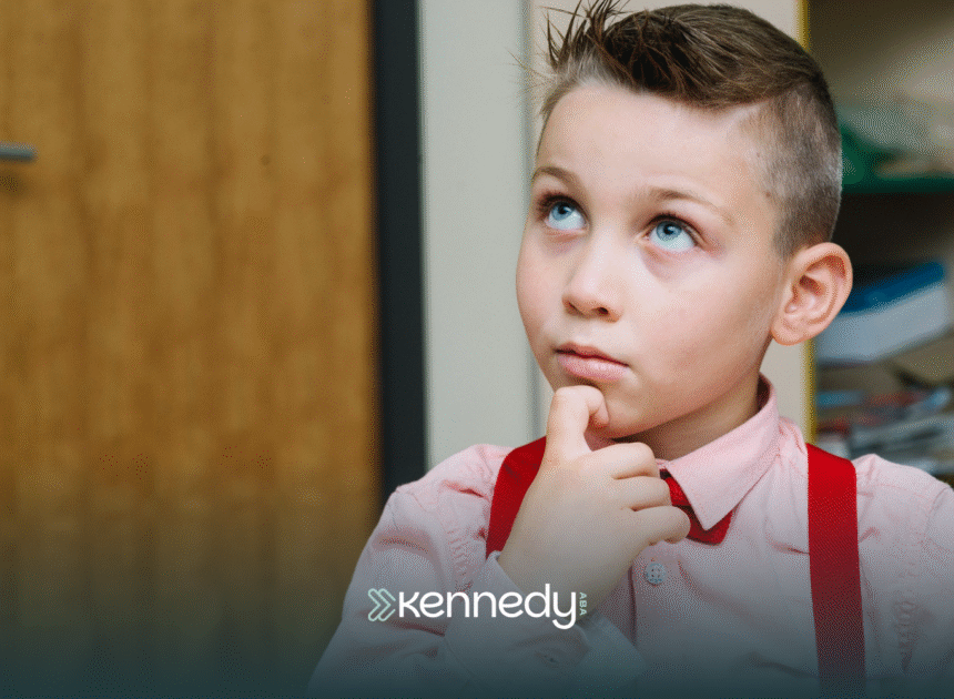 A kid with autism with his hand touching his chin, thinking