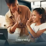 A girl high-fiving her RBT during ABA therapy