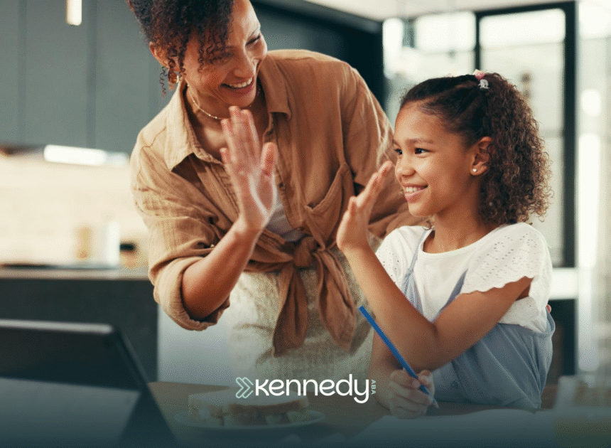 A girl high-fiving her RBT during ABA therapy