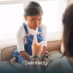 A kid with autism looking upset while being scolded