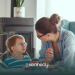 A kid wearing a pair of eyeglasses looking at his RBT during ABA therapy