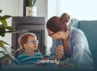 A kid wearing a pair of eyeglasses looking at his RBT during ABA therapy