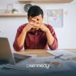 An autistic adult looking stressed at work