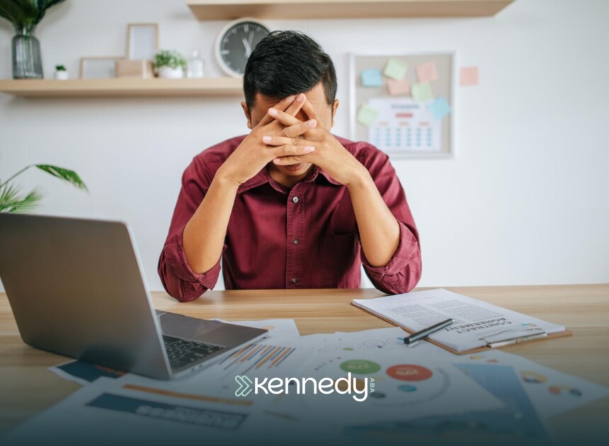 An autistic adult looking stressed at work