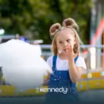 A kid eating cotton candy in Disneyland