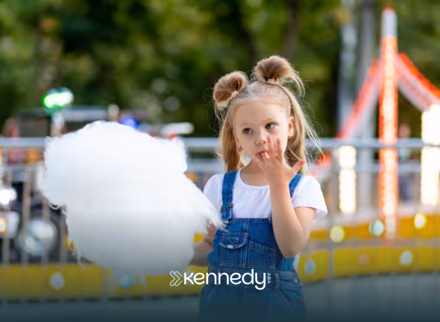 A kid eating cotton candy in Disneyland