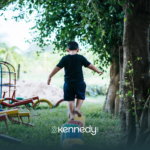 A kid with autism balancing himself on colorful tires, in a recreational spot in Atlanta, Georgia