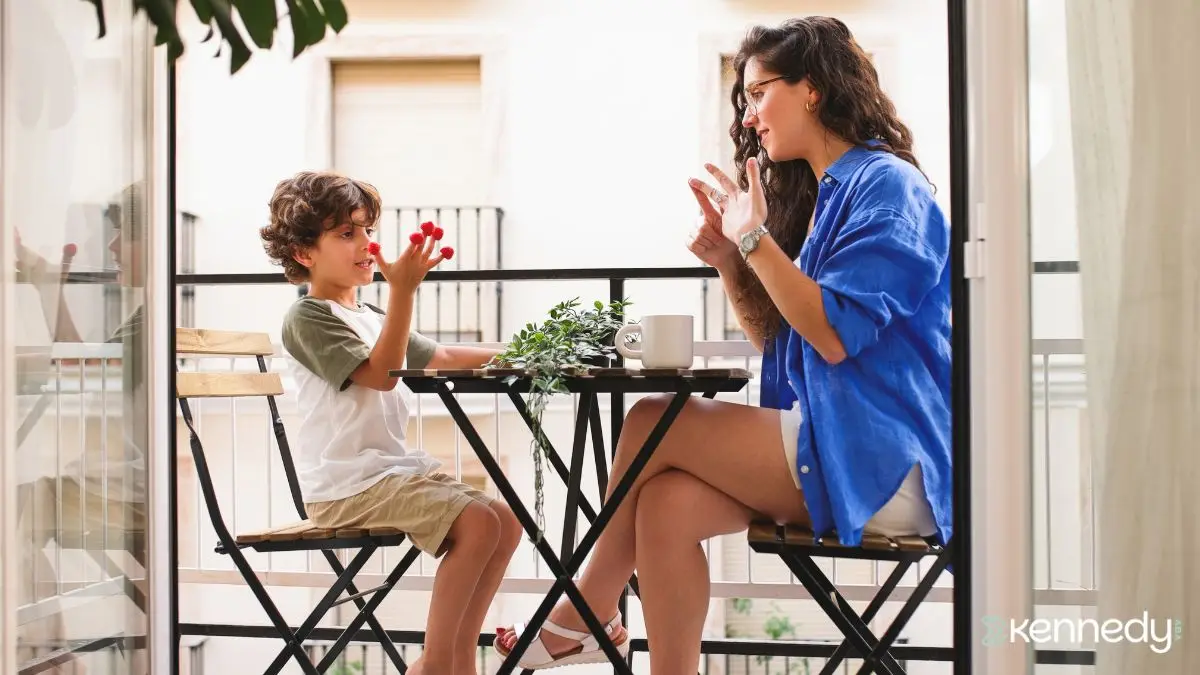 caregiver-and-child-practicing-hand-communication-during-seated-activity