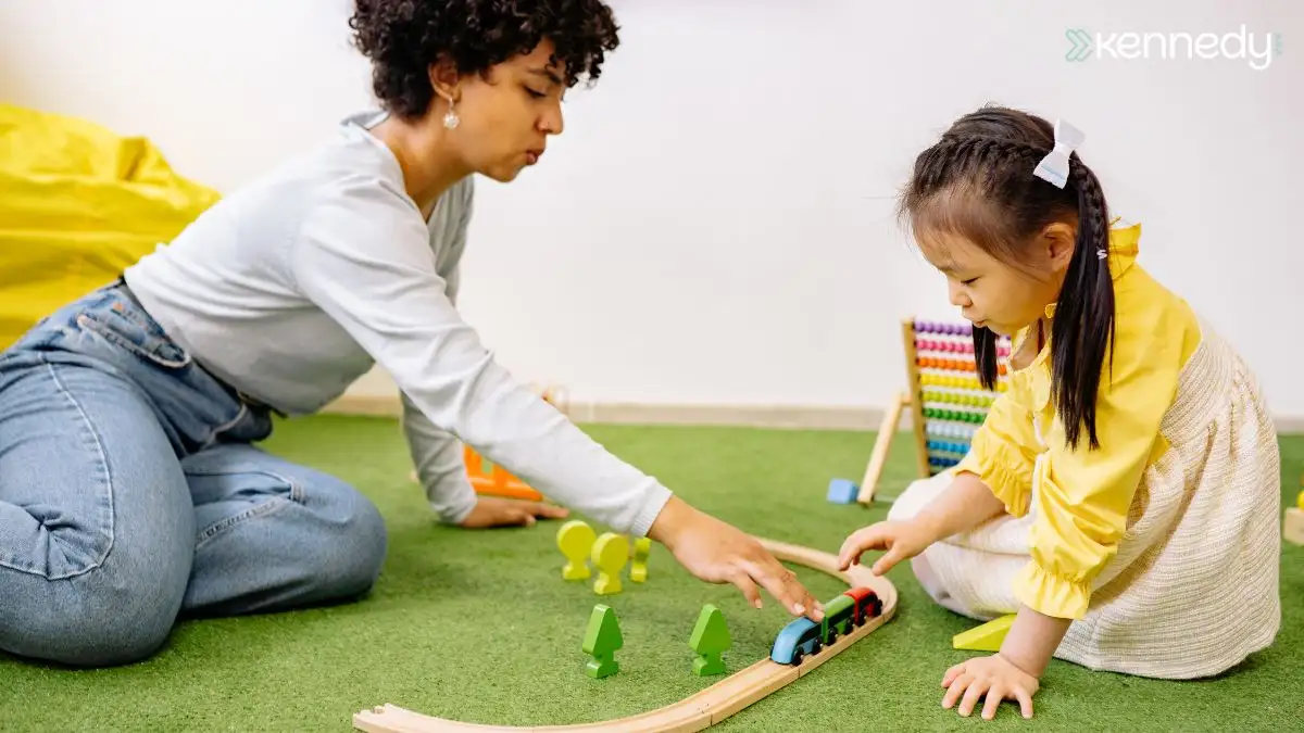 caregiver-guiding-child-during-toy-train-play-on-floor