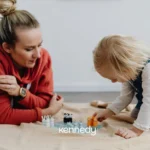 caregiver-playing-with-young-child-during-floor-based-learning-activity
