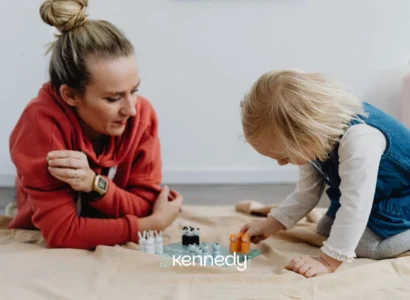 caregiver-playing-with-young-child-during-floor-based-learning-activity