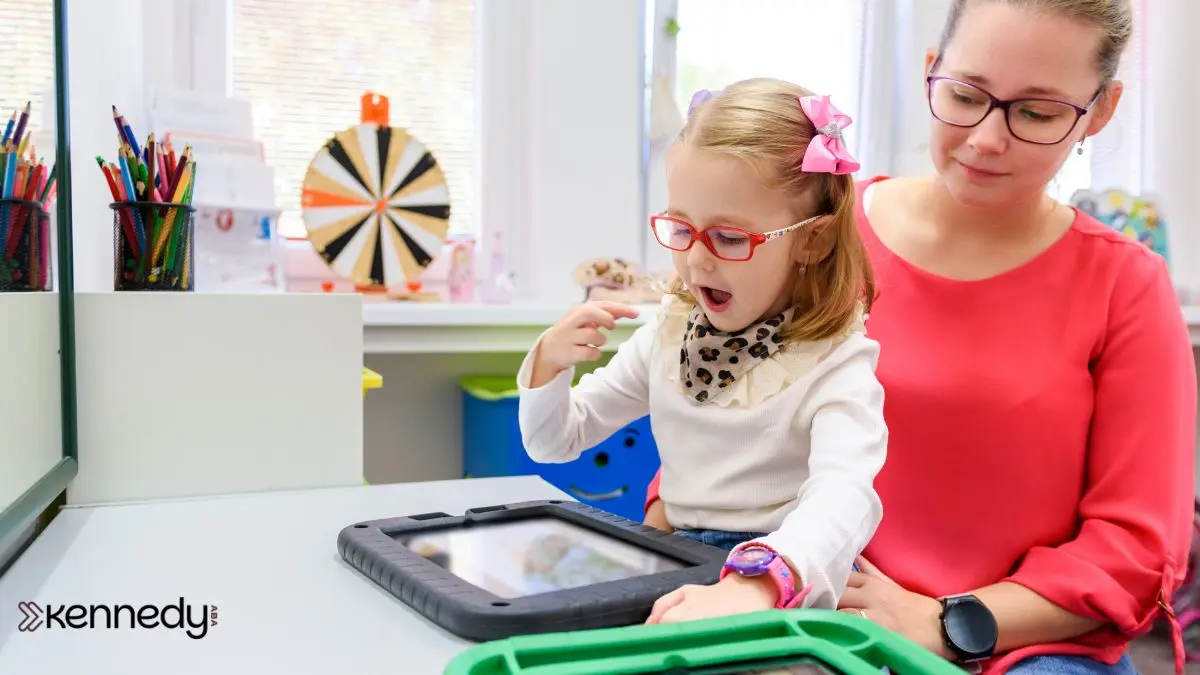 child-using-tablet-with-caregiver-support-during-learning-activity
