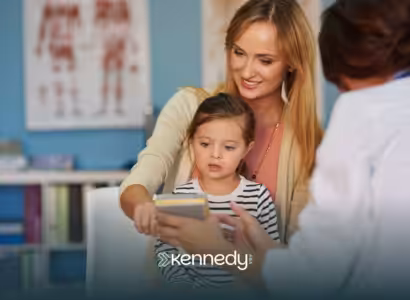 A mom with her daughter speaking to a doctor