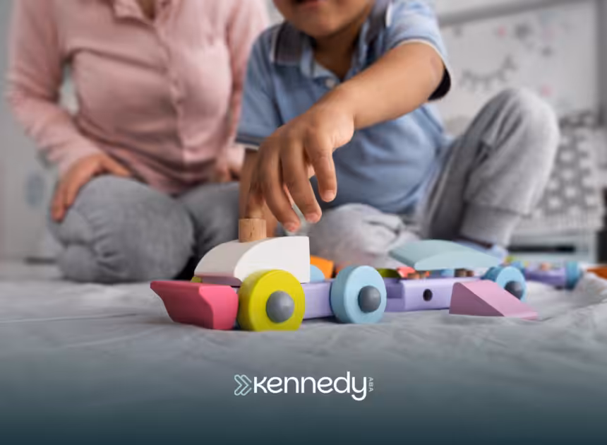 A kid and his ABA therapist playing with wooden toys during ABA therapy at home