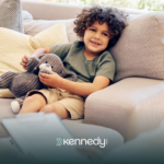 A child sitting on a couch listening to his ABA therapist